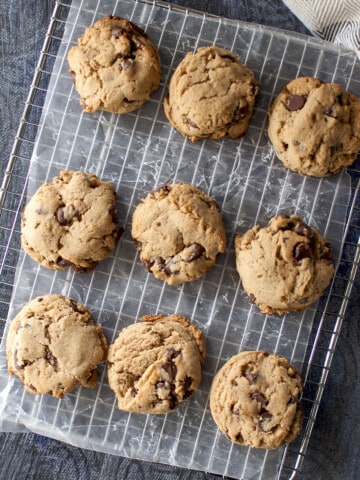 Wire rack covered with parchment paper with 9 cookies