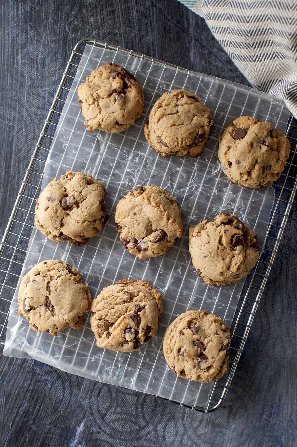 Steel wire rack topped with parchment paper and 9 cookies