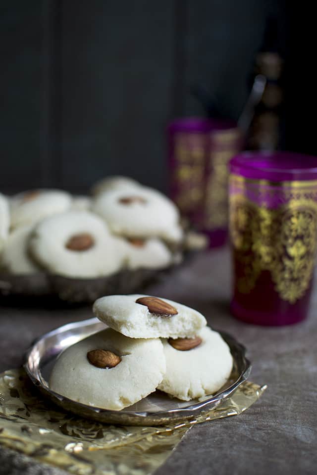 Plate with cookies topped with almonds