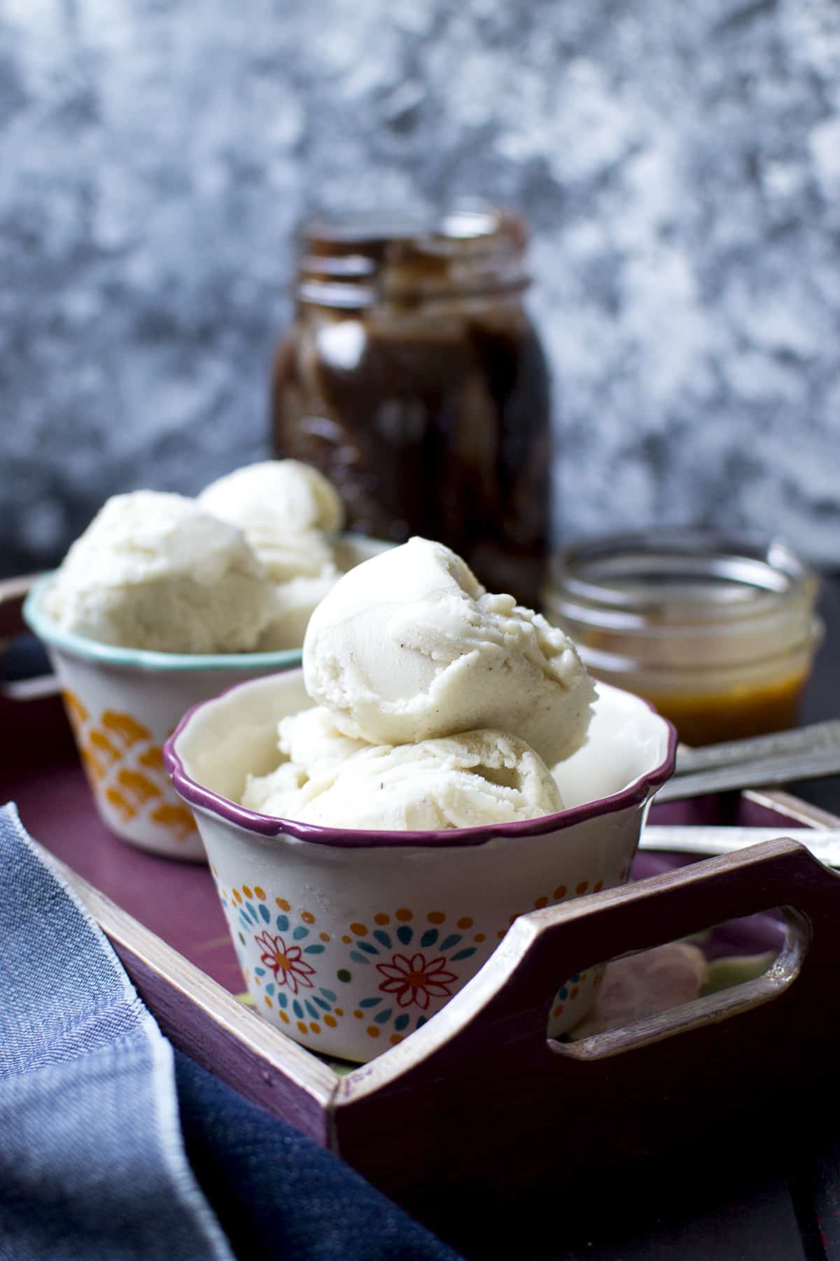 Painted bowls with scoops of sweet milk ice cream served on a tray