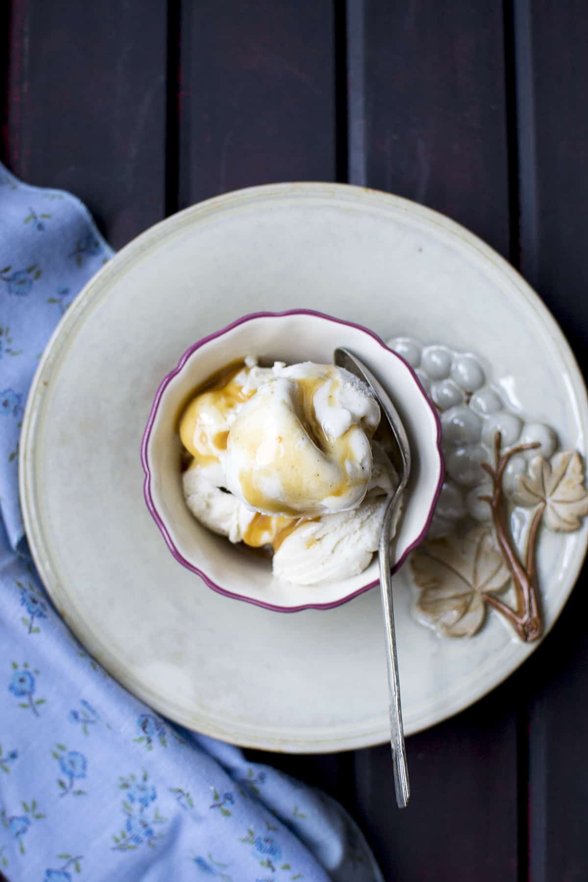 Grey plate with a bowl of vanilla frozen treat