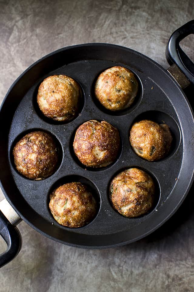 Aebleskiver pan with cooked wheat flour kuzhi paniyaram