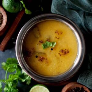 Top view of a steel bowl with nimmakaya charu.