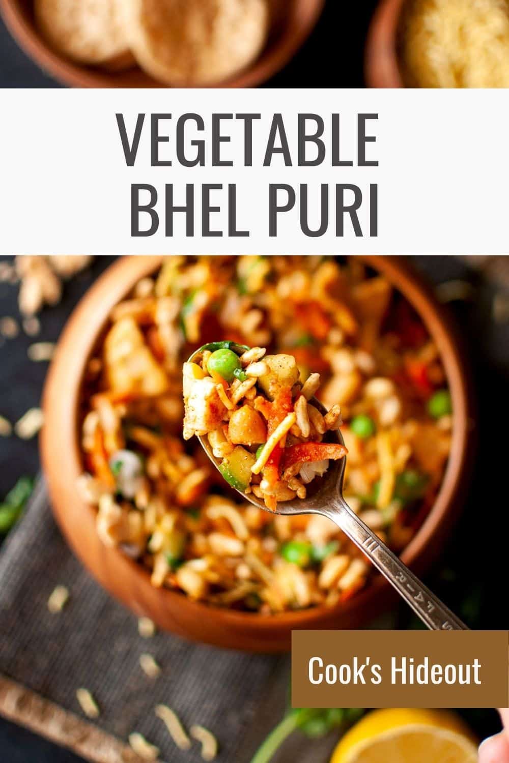 Spoon with veg bhel puri over a wooden bowl.