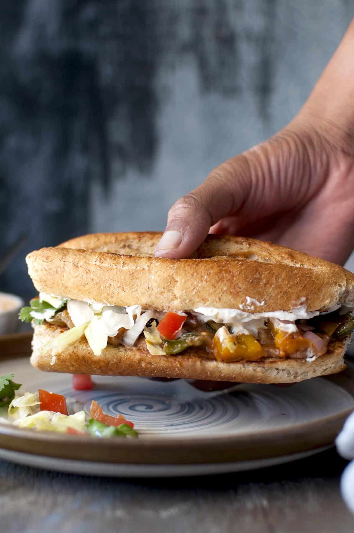 Hand holding a vegetarian torta