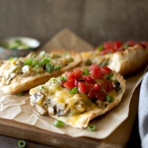 Baking sheet with mushroom and cheese open face sandwich.