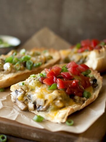 Baking sheet with mushroom and cheese open face sandwich.