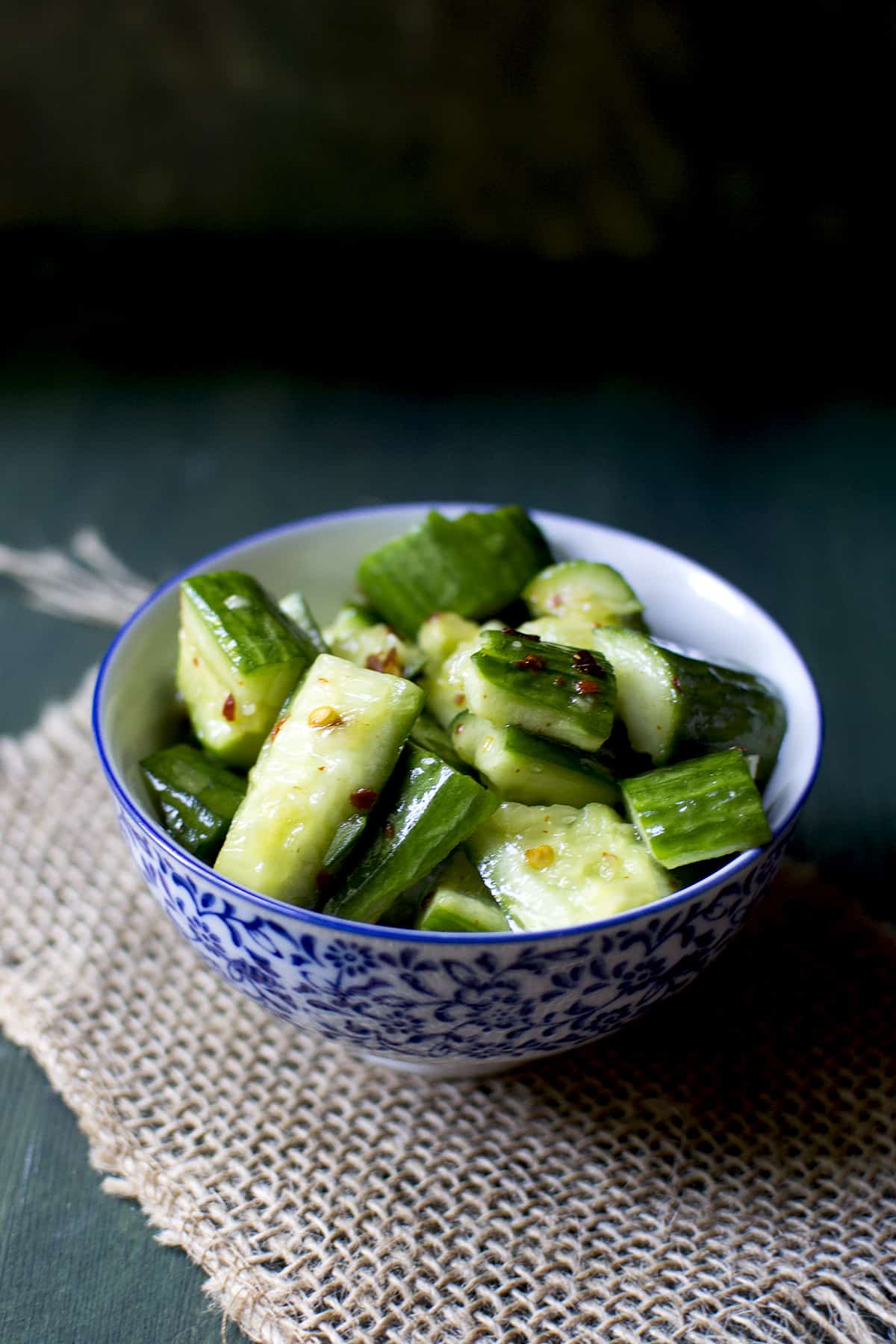 white and blue bowl with cuke salad