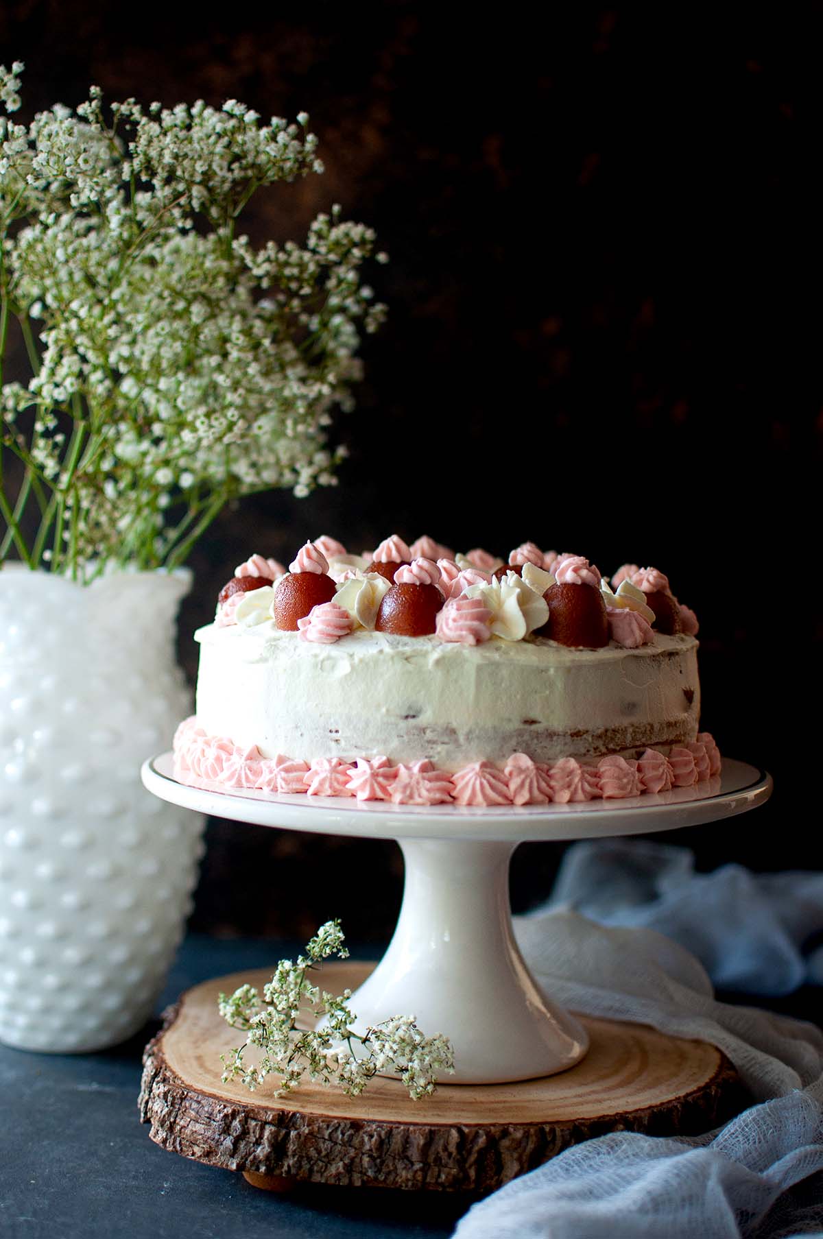 White cake stand with eggless gulab jamun cake