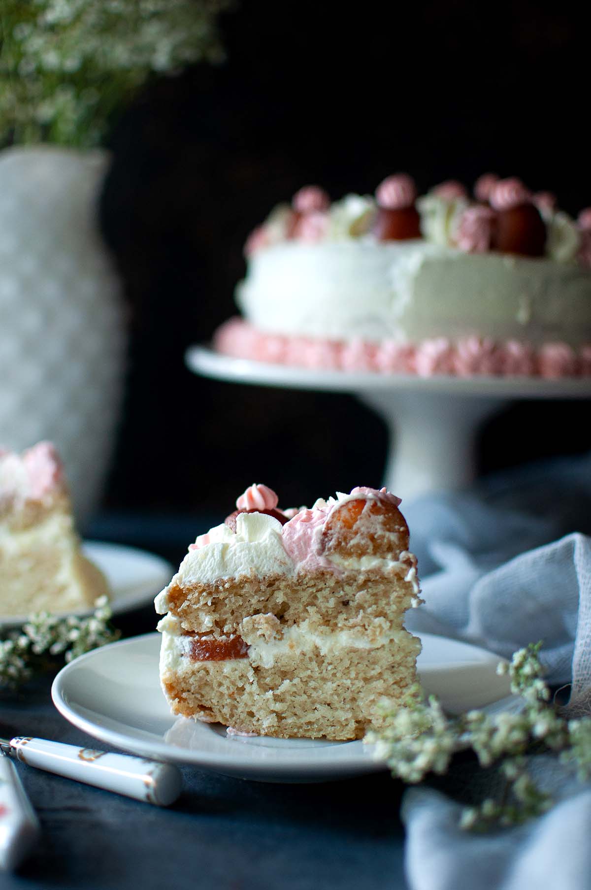 White plate with a slice of gulab jamun cake