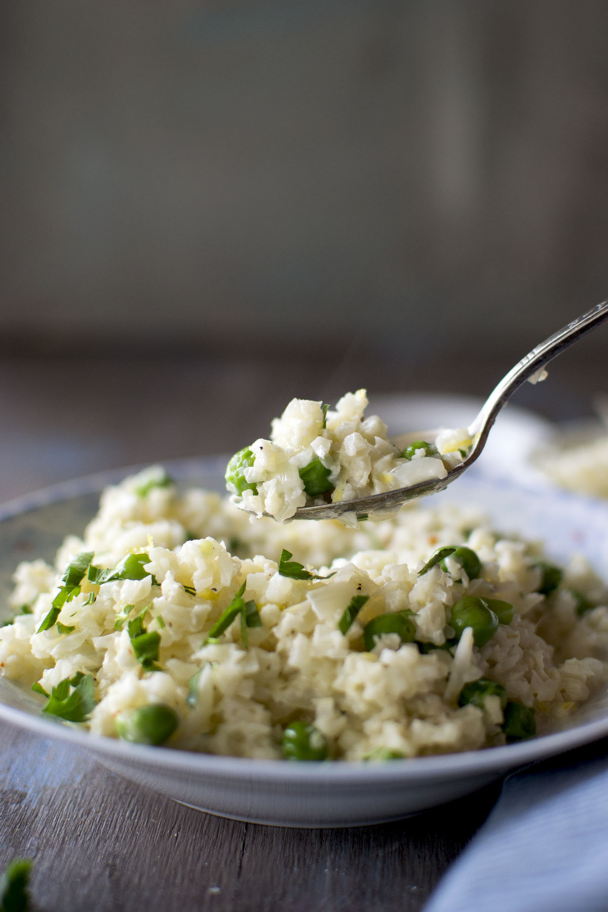 Spoon with rice and green peas