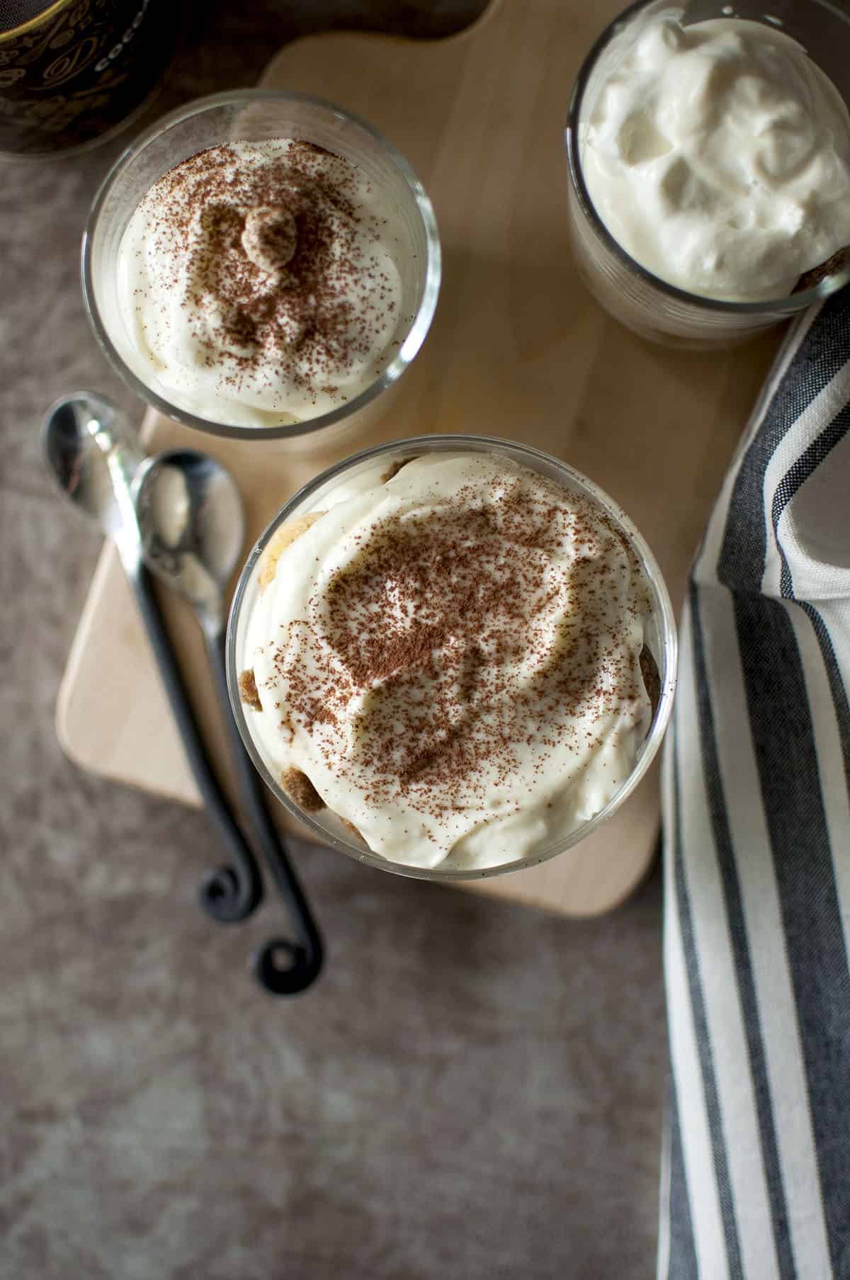 Top view of individual tiramisu dessert sprinkled with cocoa powder