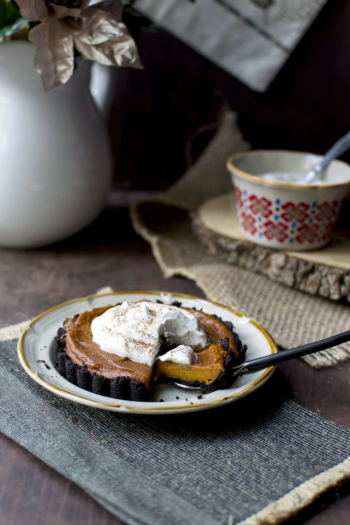 Grey plate with a mini tart - spoon holding a piece