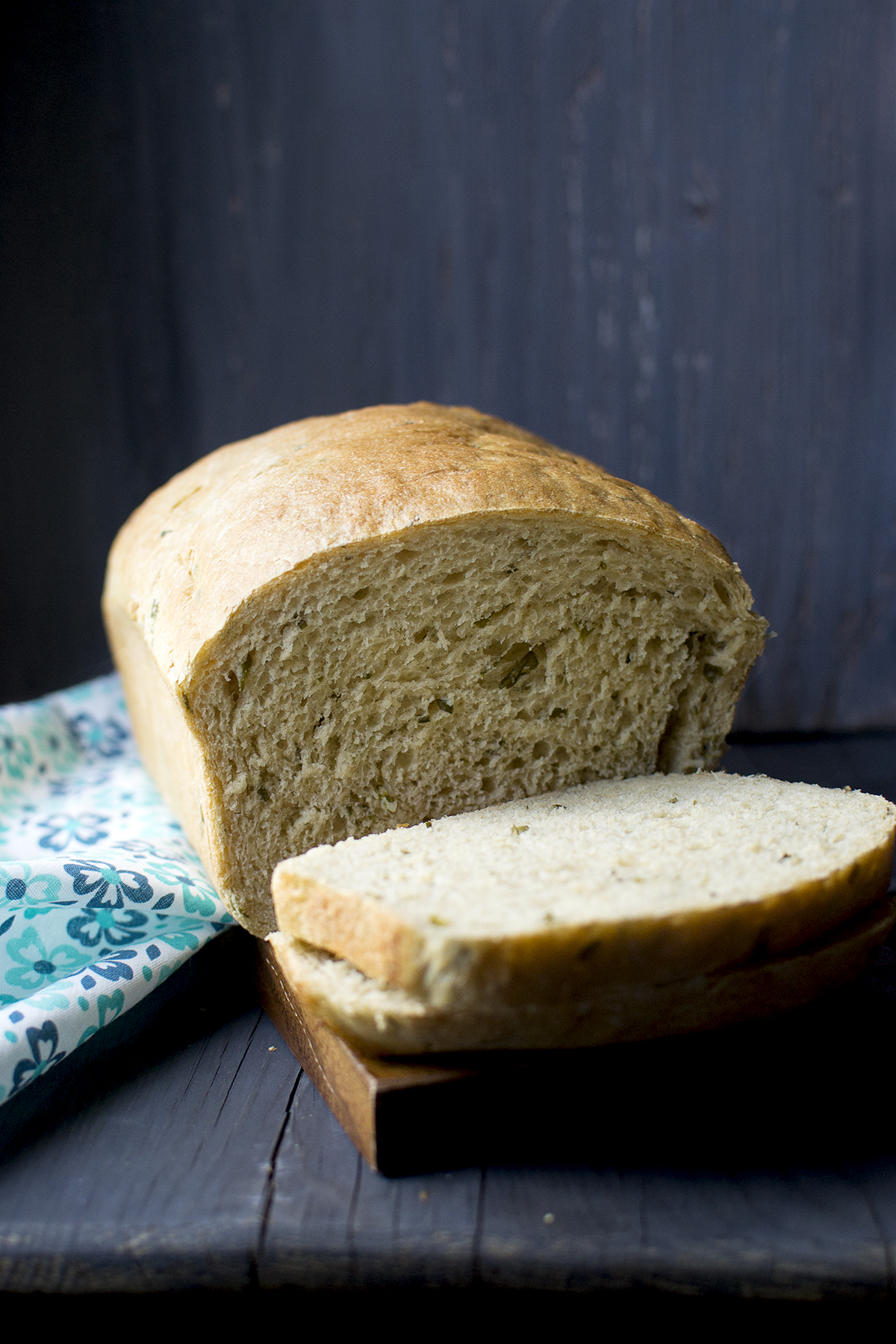 Chopping board with sliced chive bread