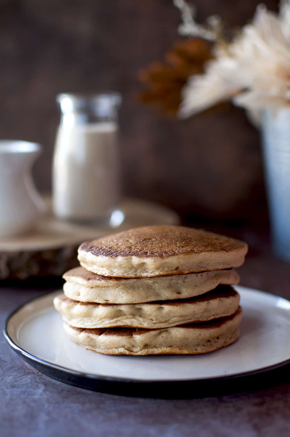 White plate with a stack of vegan eggnog pancakes