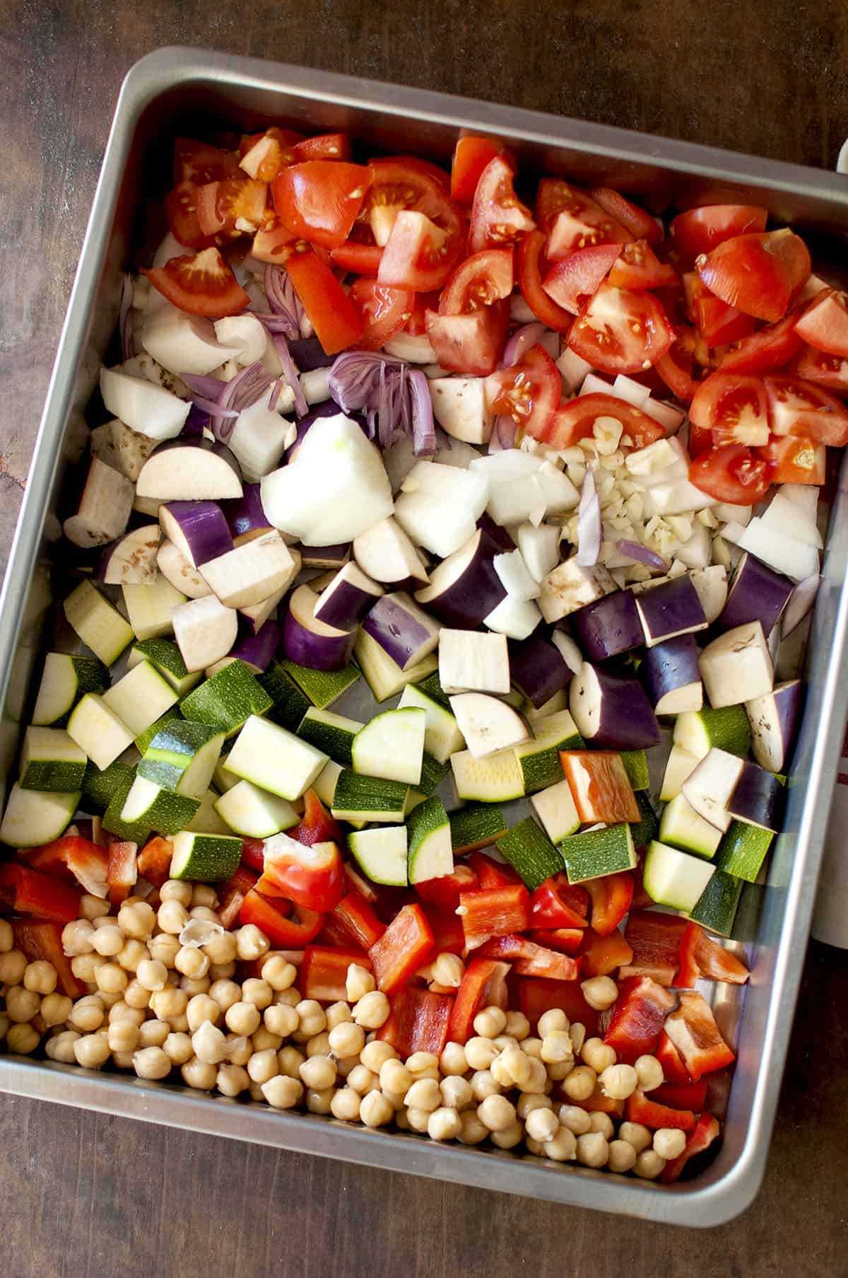 Roasting pan with chopped vegetables and chickpeas