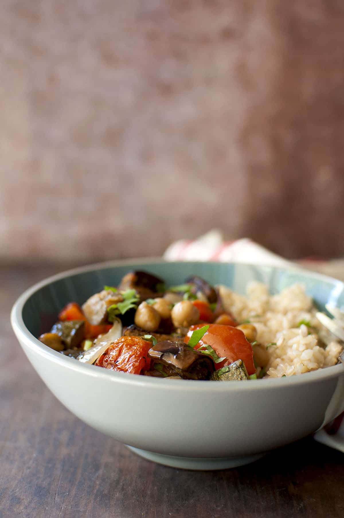 Grey bowl with brown rice and roasted vegetables