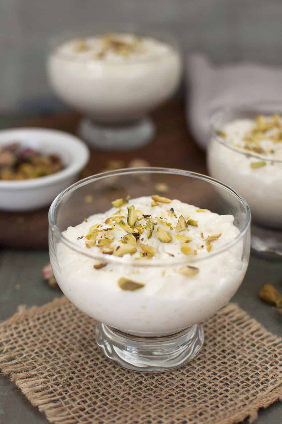 Dessert served in a glass topped with chopped nuts