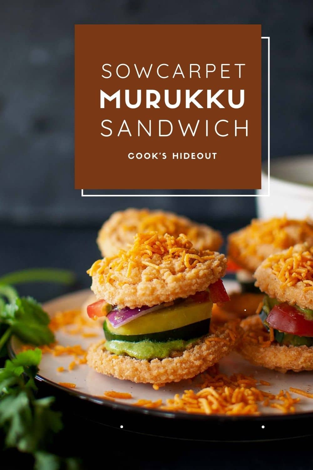 White plate with murukku and veggie sandwich.