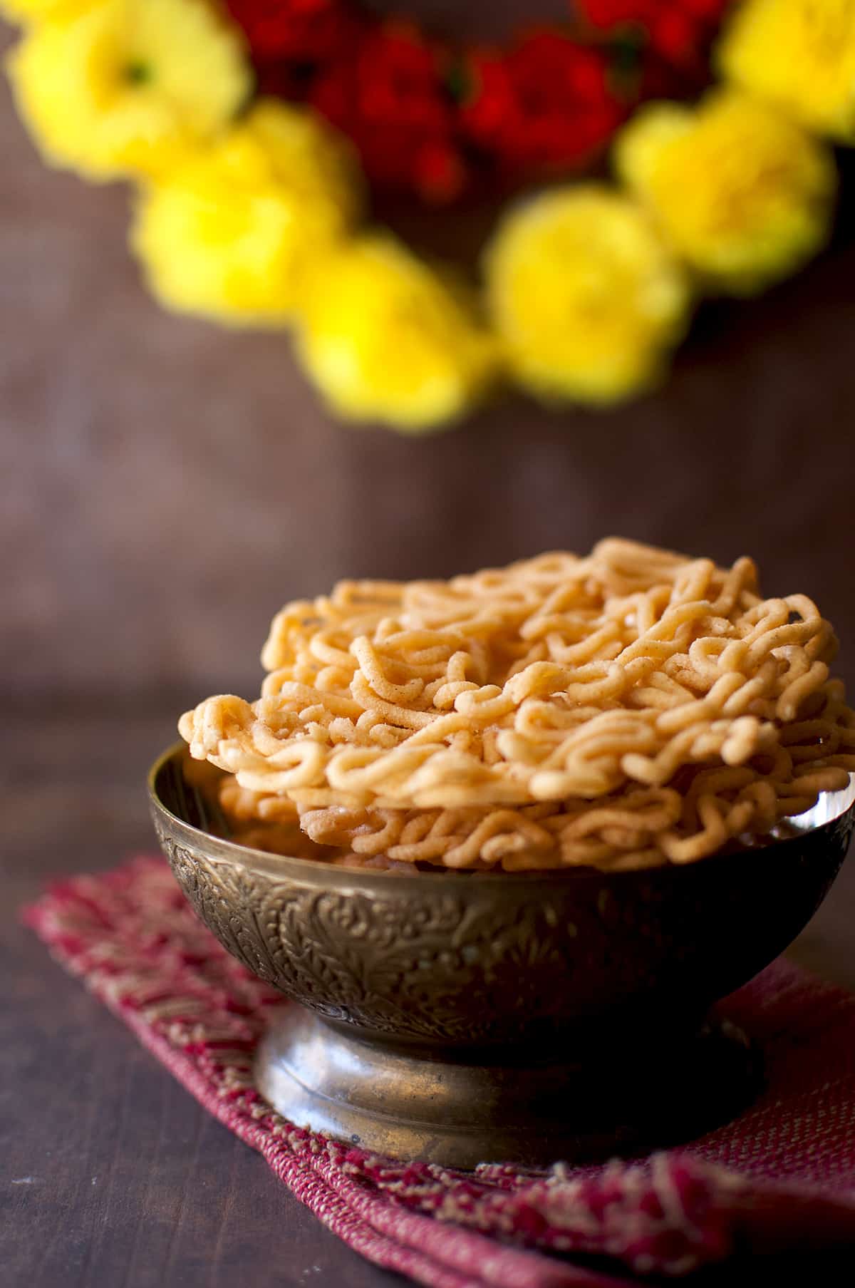 Brass bowl with a stack of janthikalu