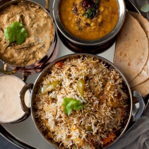 Steel plate with rice, dal, curry and roti