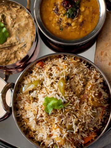 Steel plate with rice, dal, curry and roti