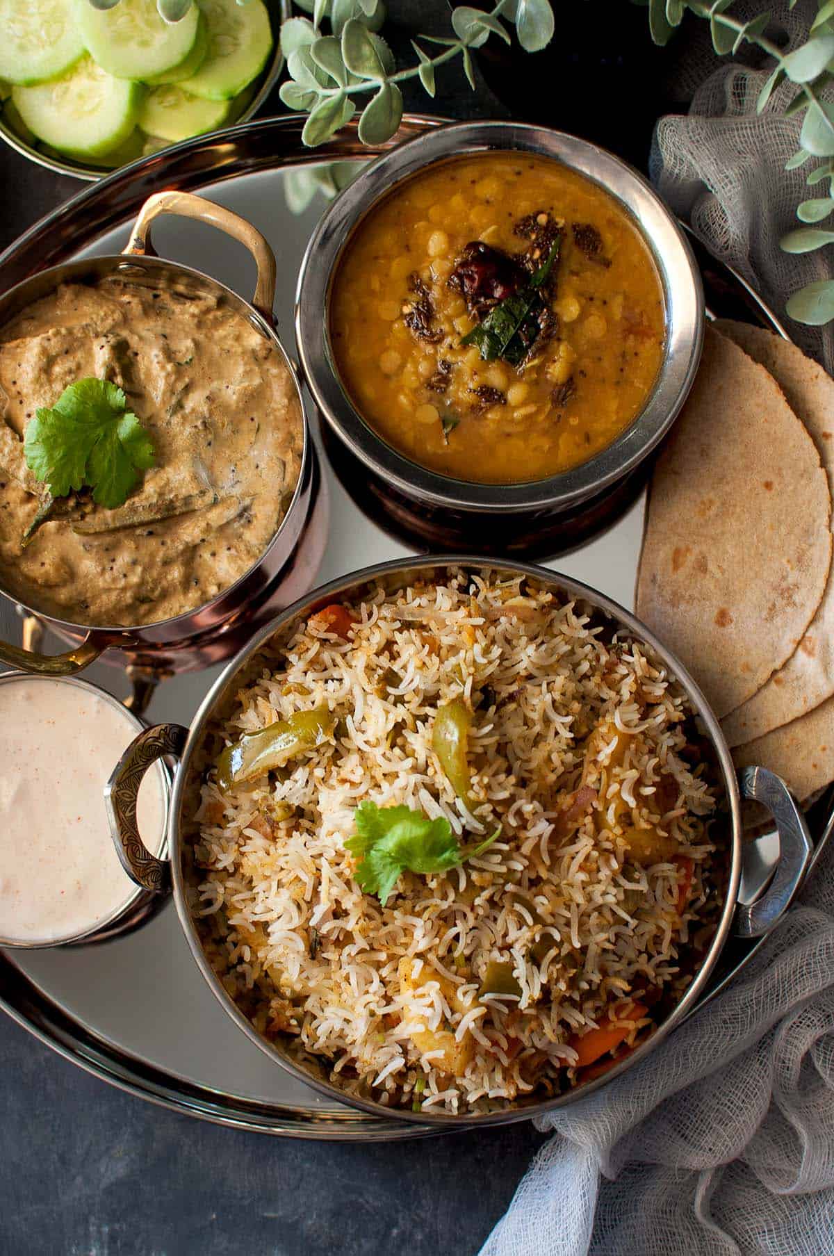 Steel plate with rice, dal, curry and roti