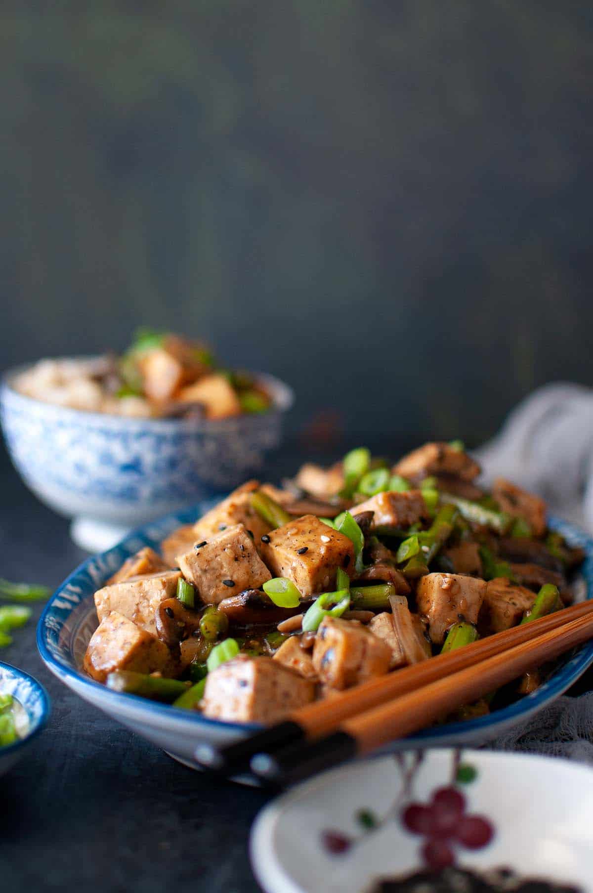 Blue plate with sesame tofu stir fry.