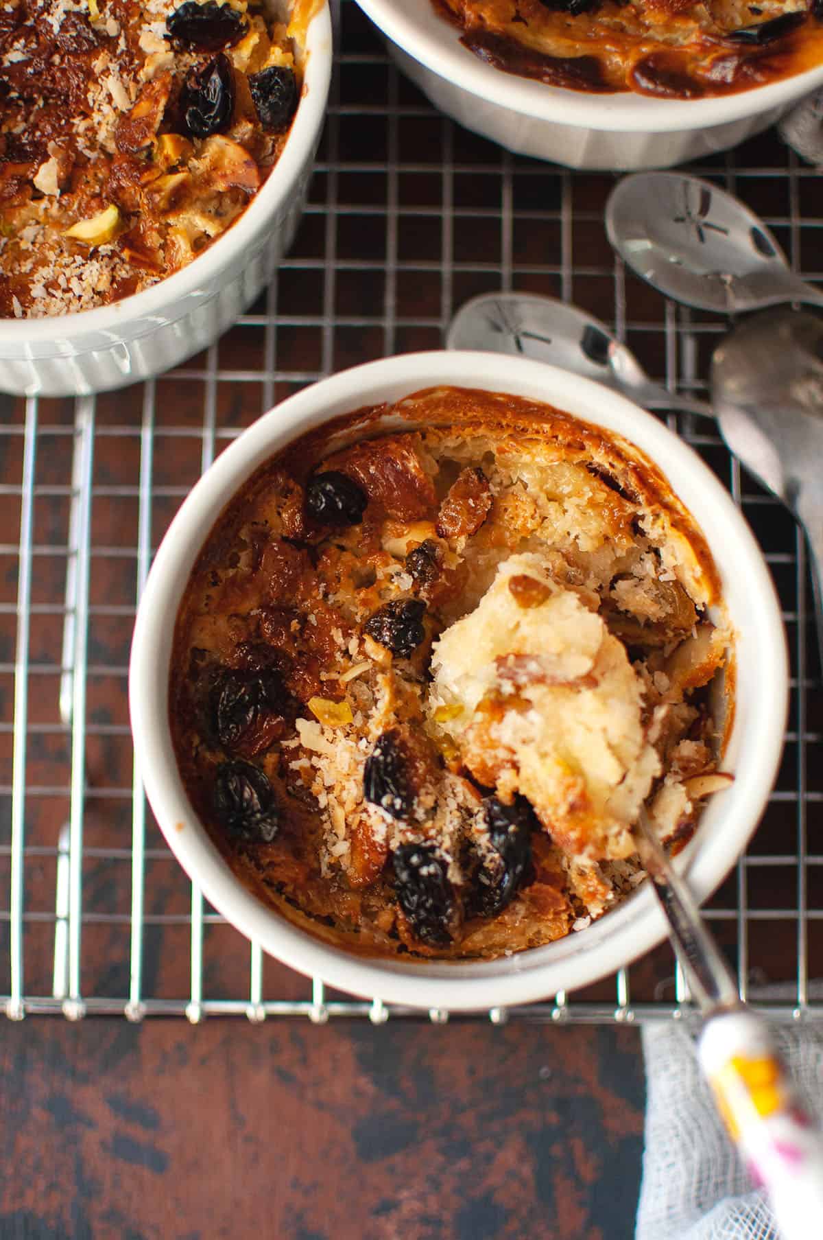 Top view of a white ramekin with baked umm ali dessert.