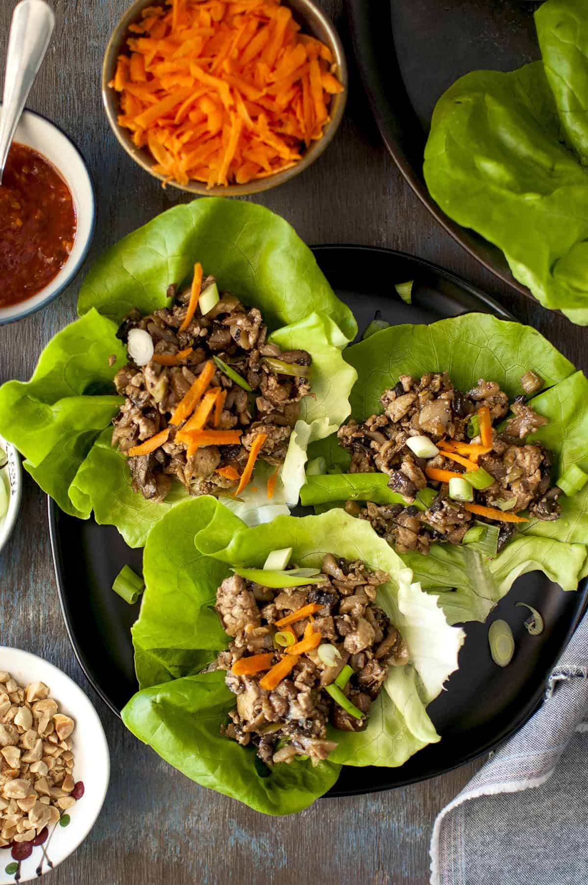 Tray with Tofu lettuce wraps topped with carrot and peanuts