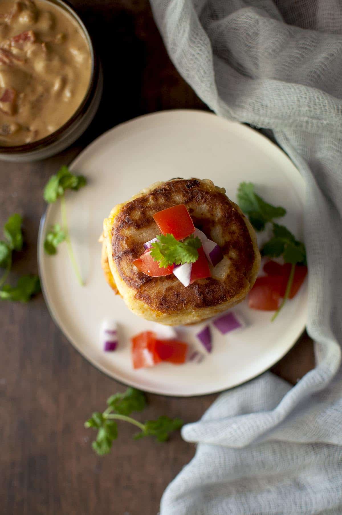 Top view of potato pancakes topped with chopped tomatoes