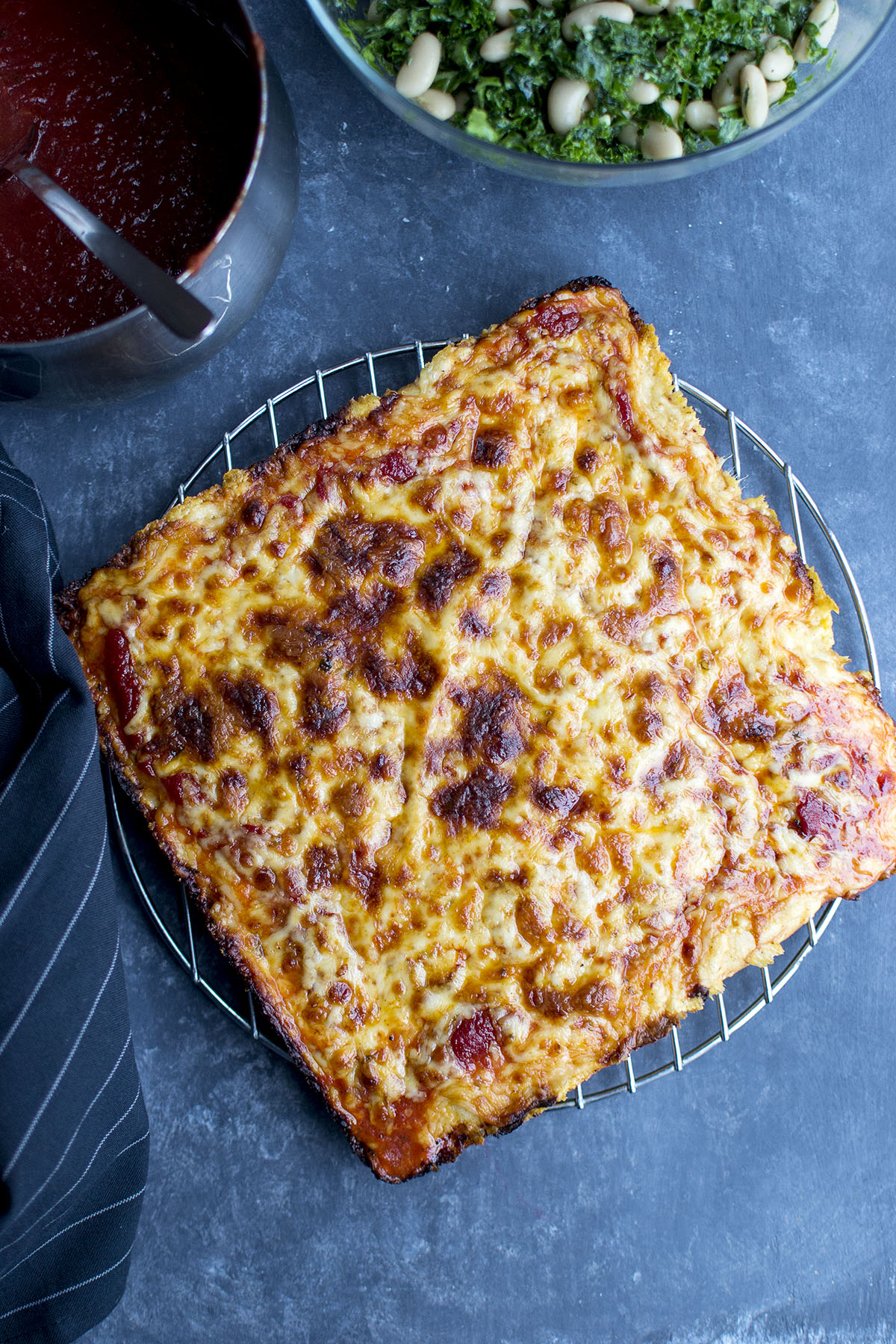 Steel rack with cheese pizza