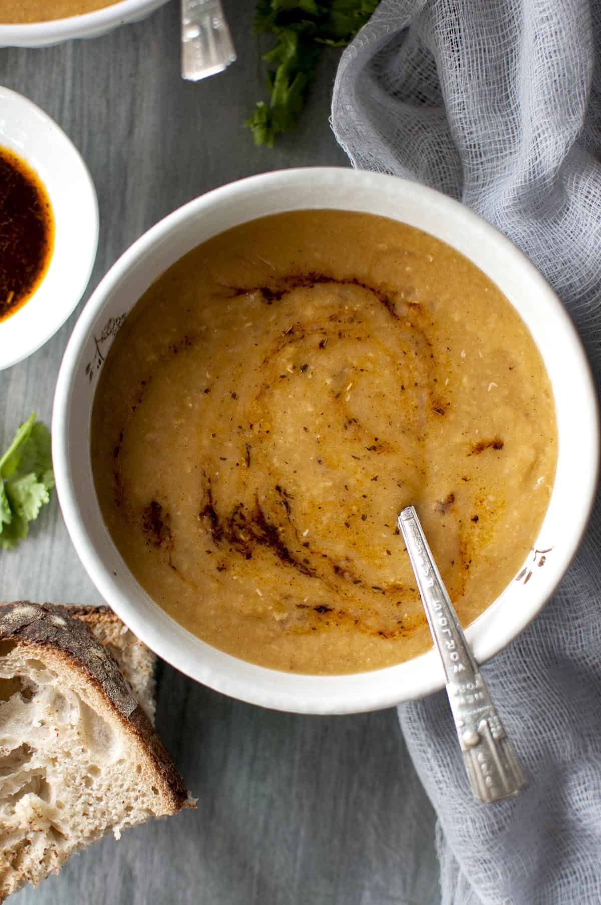 White bowl with soup and spoon