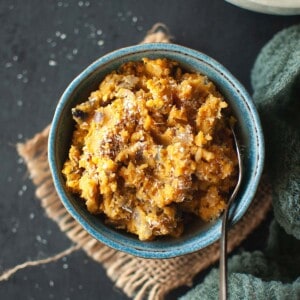 blue bowl with Sri Lankan dhal curry and a spoon.