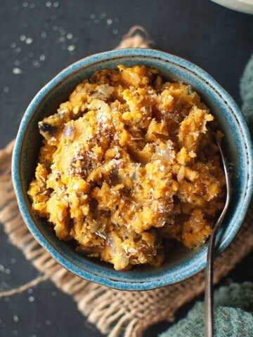 blue bowl with Sri Lankan dhal curry and a spoon.