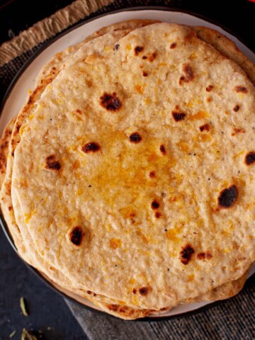 Top view of white plate with pumpkin roti