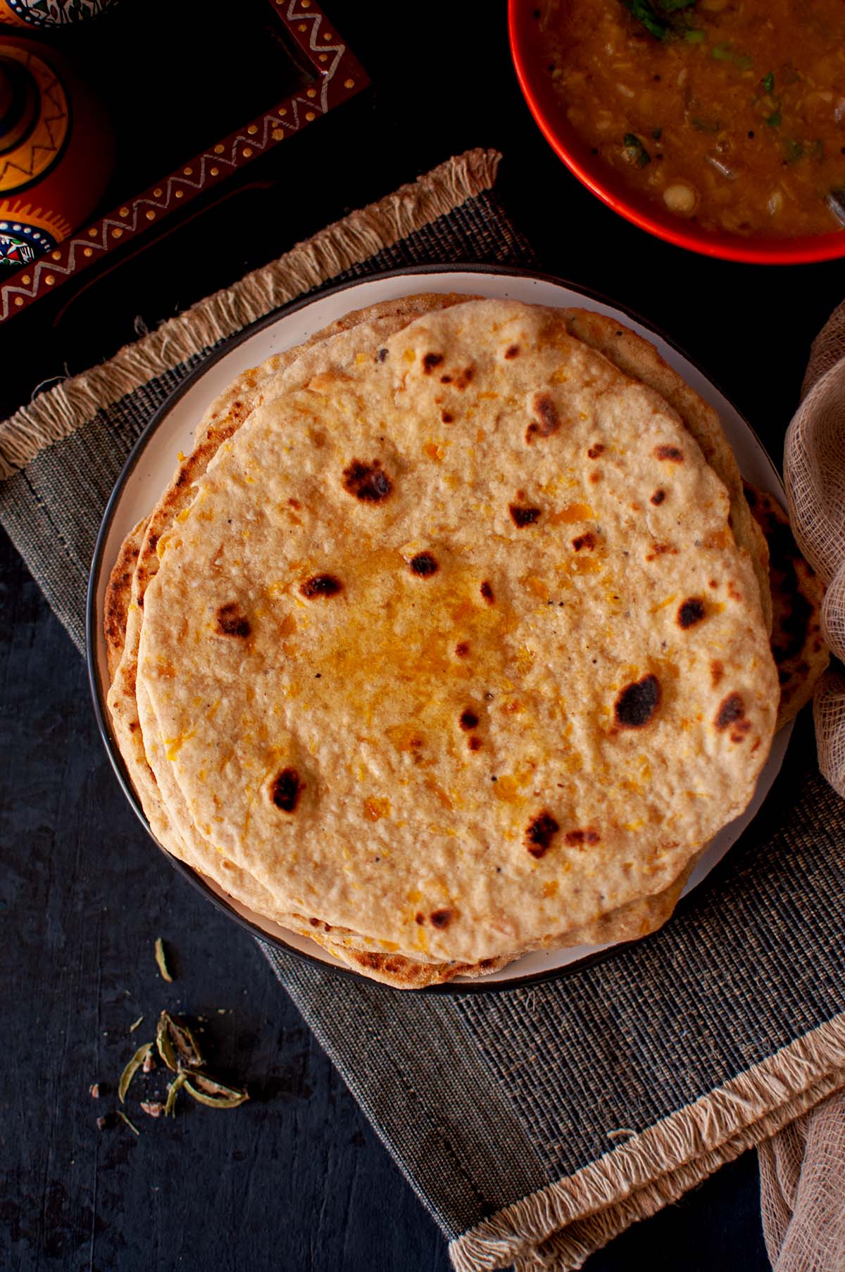 Top view of white plate with pumpkin roti