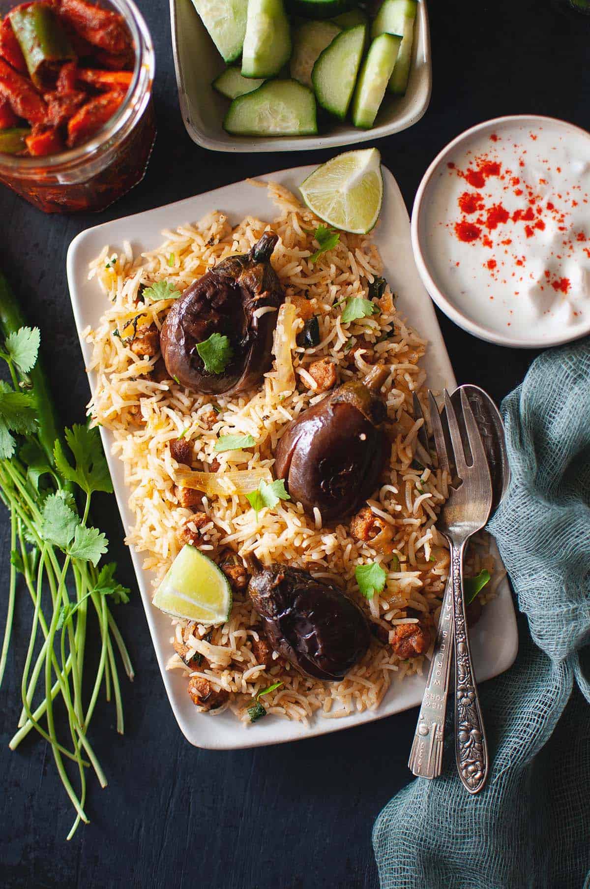 Top view of rectangular plate with baby eggplant rice.