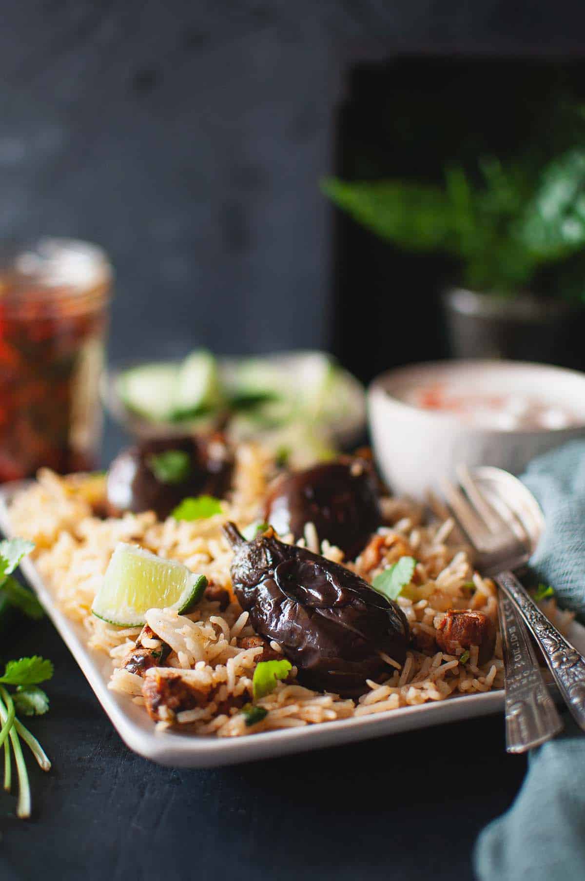 White plate with gutti vankaya pulao.