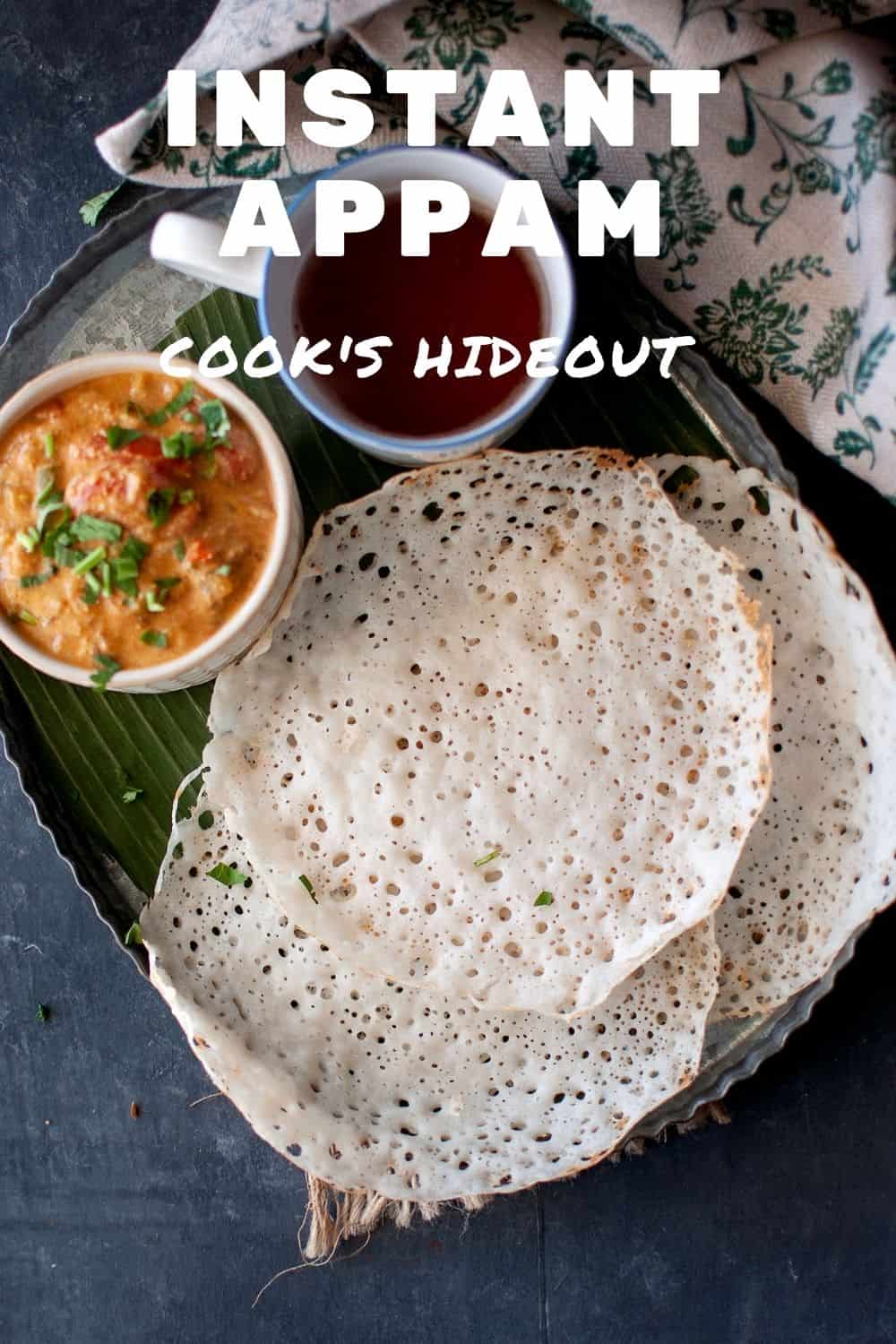 Tray with spongy instant appam with curry and a mug of tea.