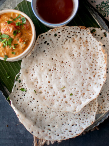 Breakfast platter with South Indian crepes with curry and tea.