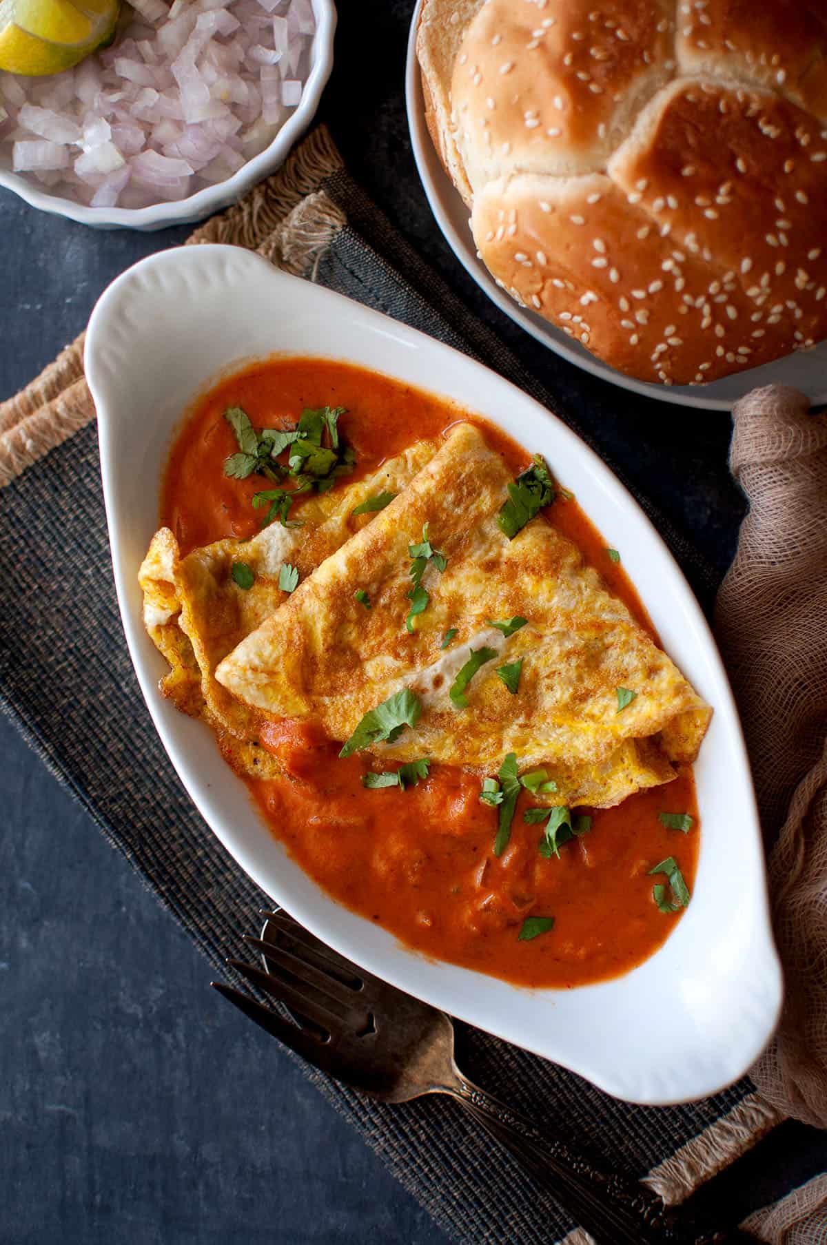 White oval bowl with ras omelette.