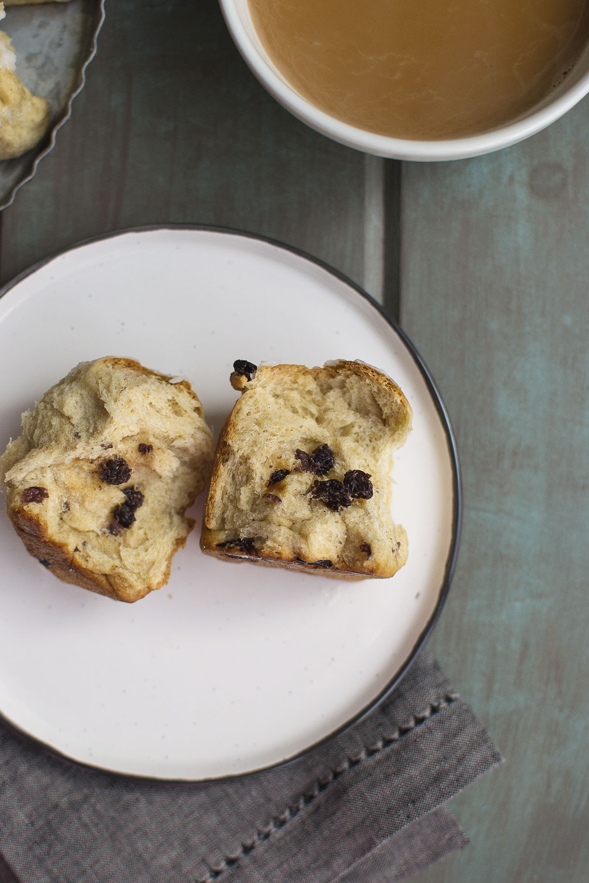 White plate with slit sweet bun with raisins