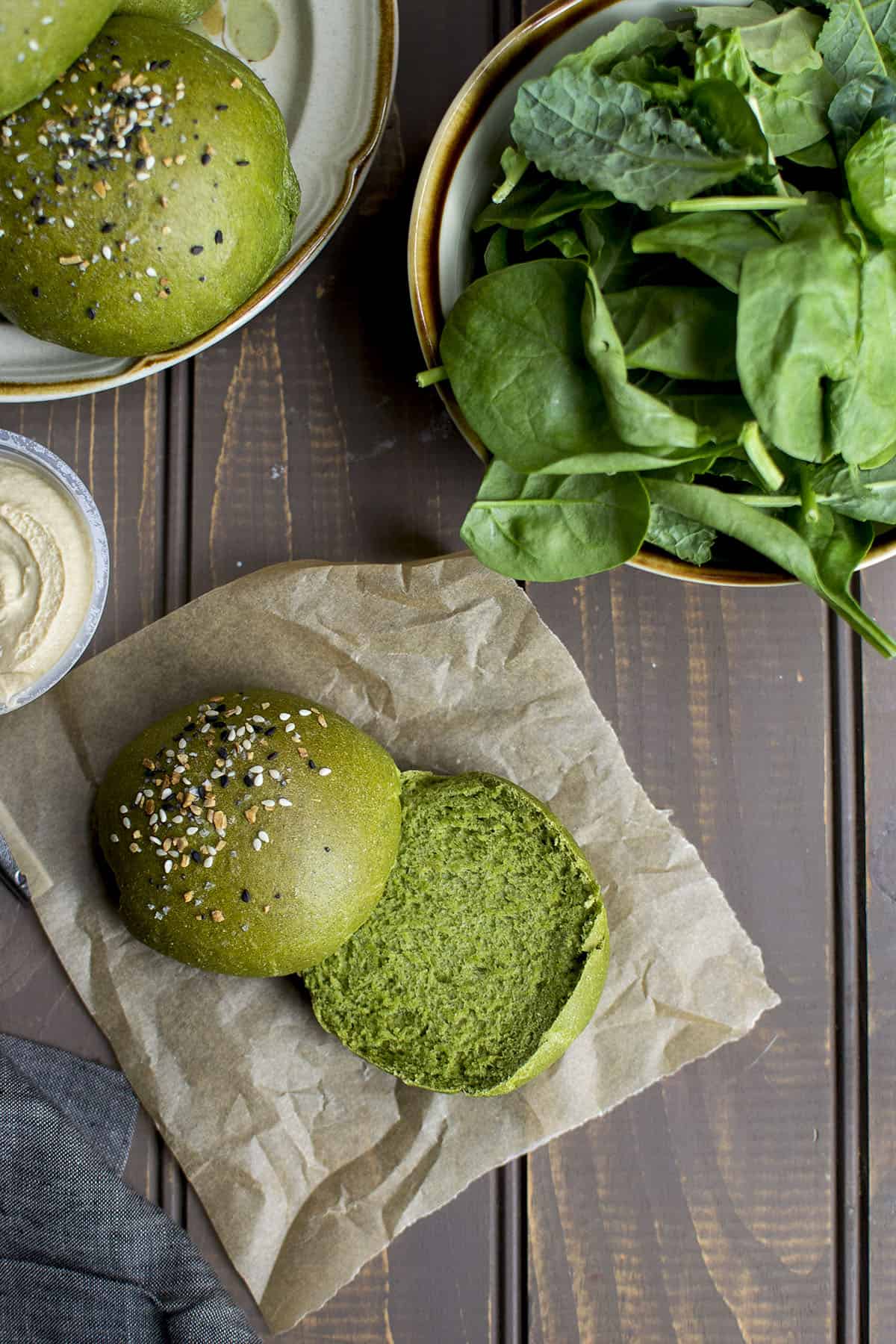 Parchment paper with a split Spinach Burger Bun