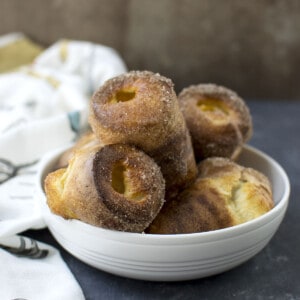 White bowl with cinnamon sugar dusted popovers