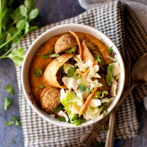 Top view of a bowl of Burmese samosa soup topped with cabbage.