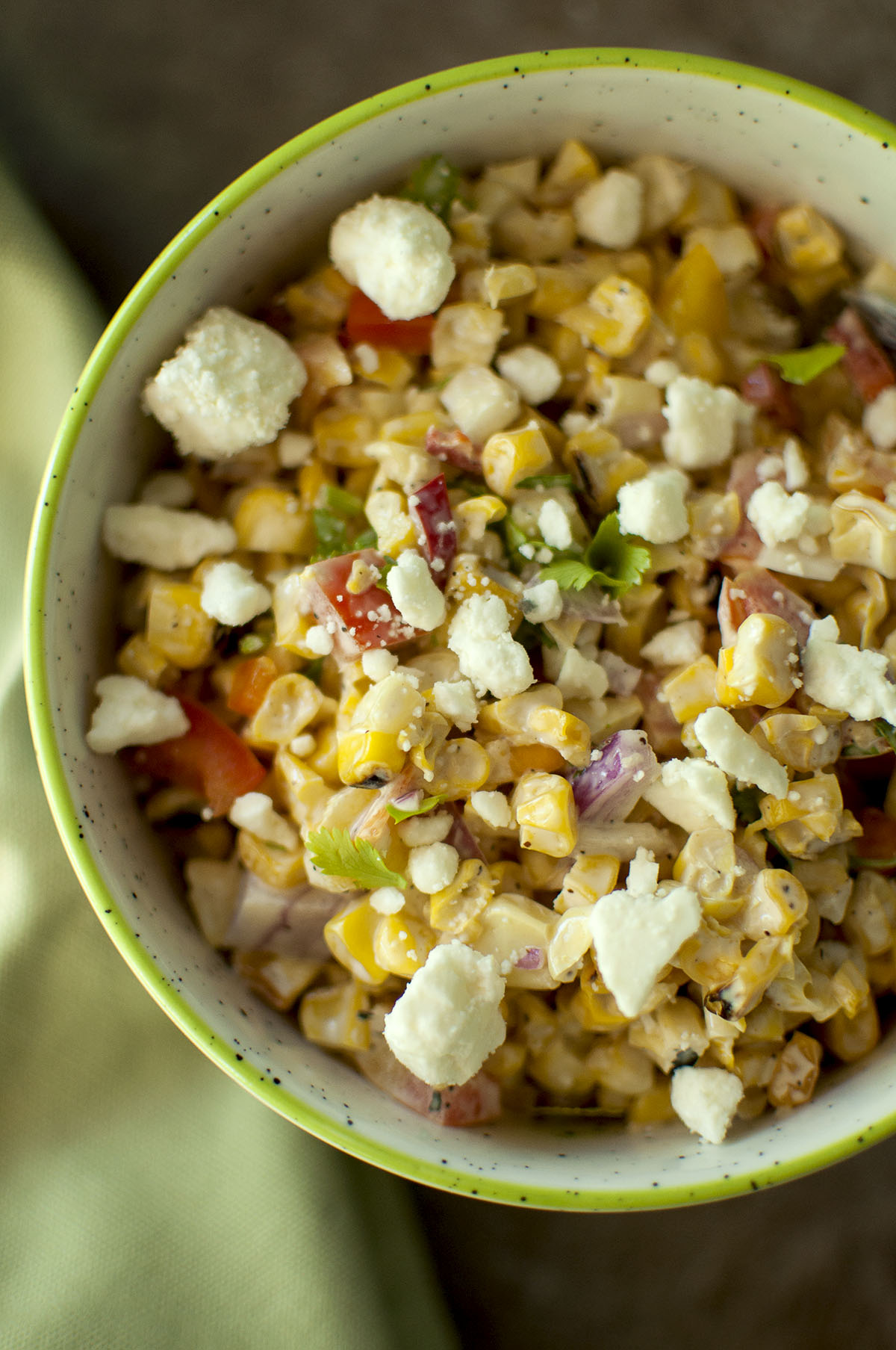 White bowl with Mexican Grilled Corn topped with cheese