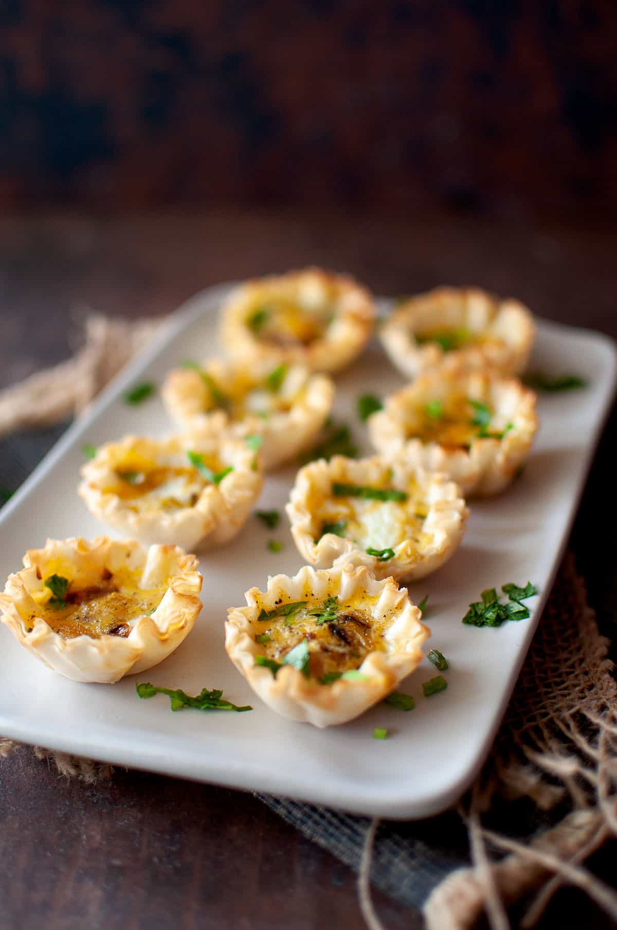 White plate with mini vegetable quiches.