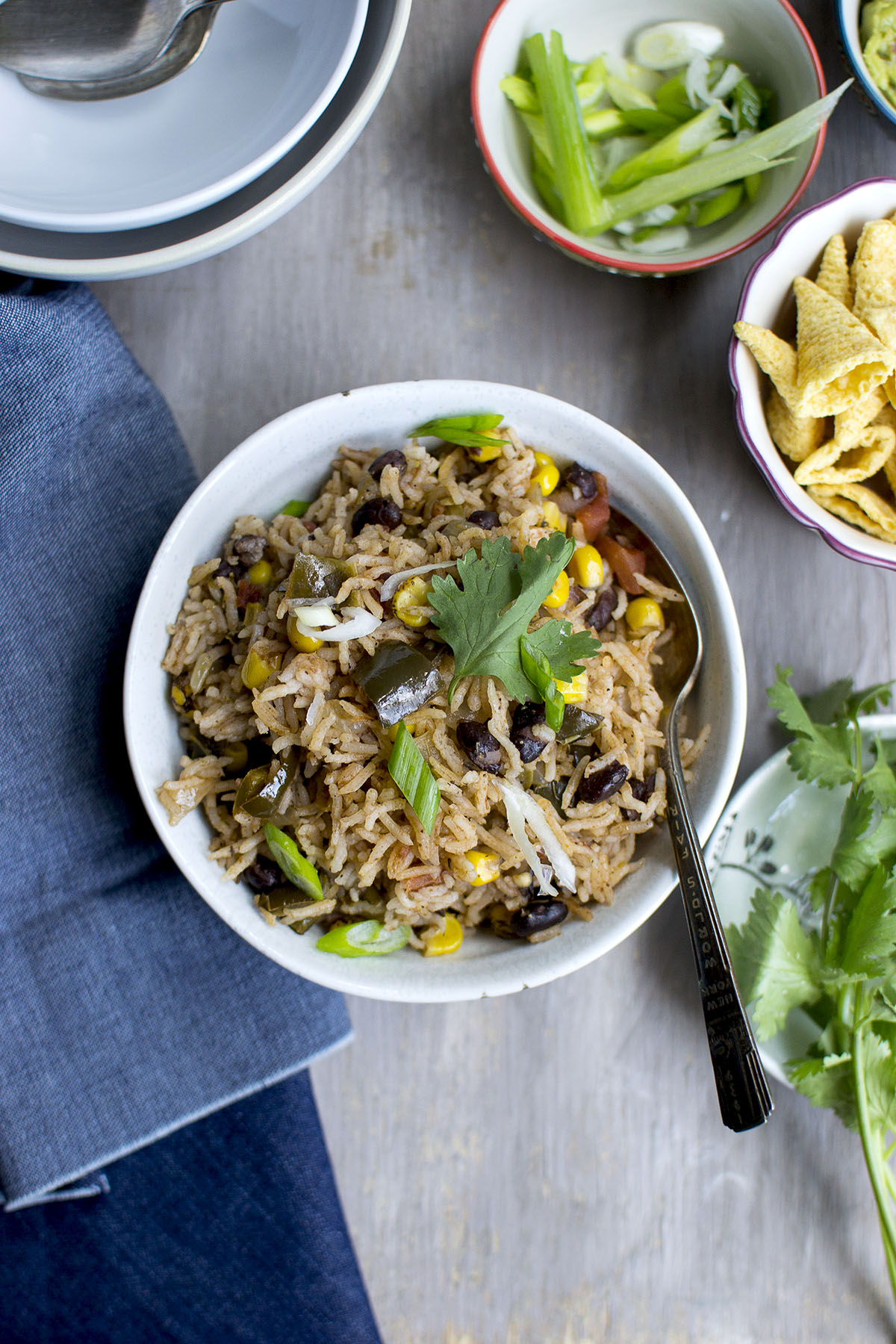 Grey bowl with vegetarian black beans and rice topped with cilantro and scallions.