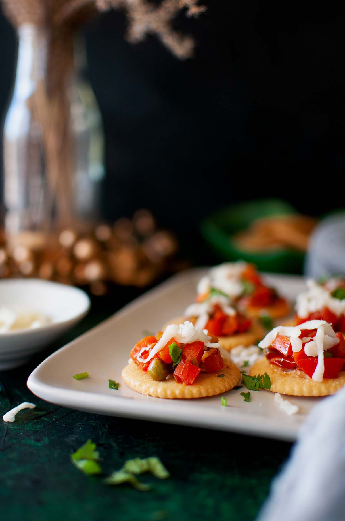 White plate with vegetable dip topped crackers